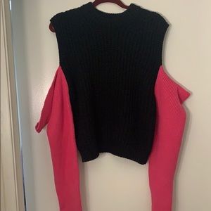 Black and hot pink sweater. open shoulder